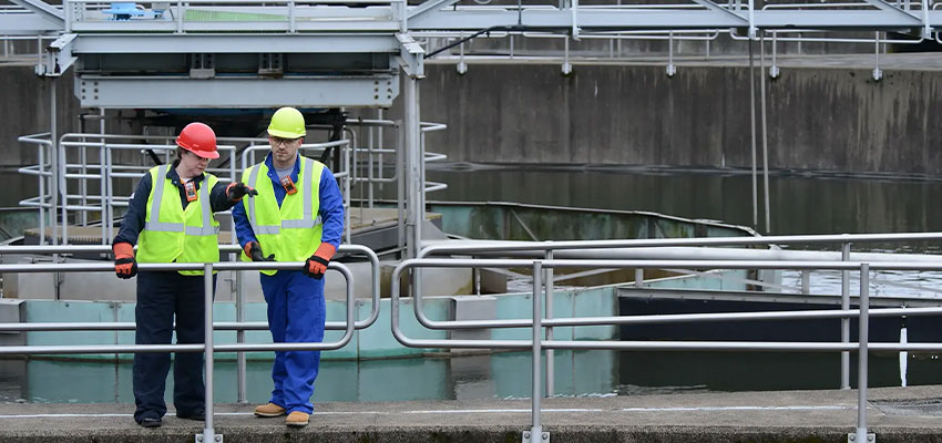 Wastewater treatment facility workers wearing personal multi gas detection monitors