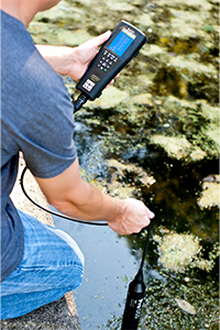 Worker conducting groundwater sampling with a YSI Multiparameter Meter